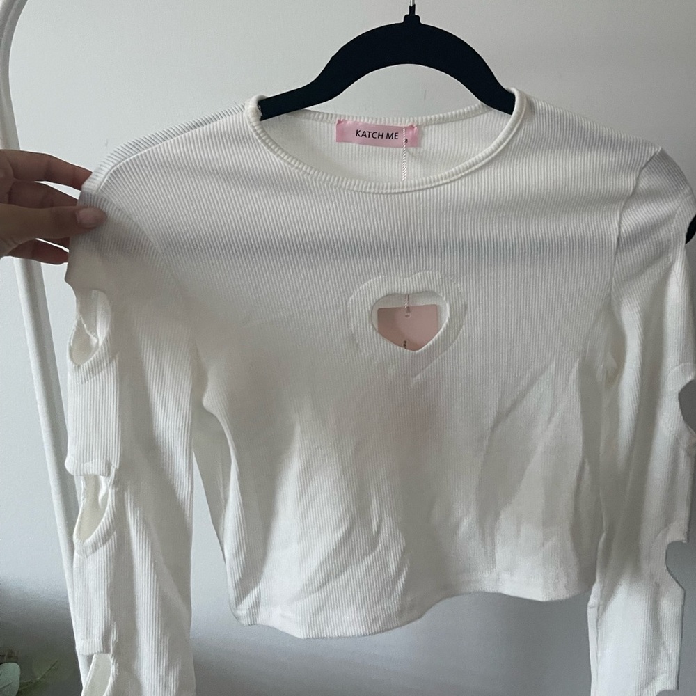white long sleeve top with heart cut outs